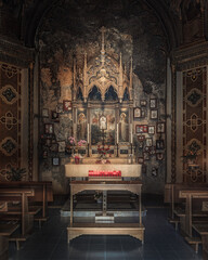 Ornate Altarpiece and Votive Offerings in an Ancient Chapel