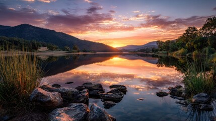 "Stunning sunset over a lake and mountains, creating a scenic landscape view of nature's beauty