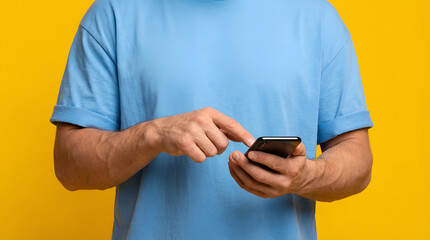 Man Holding Smartphone Against Bright Yellow Background