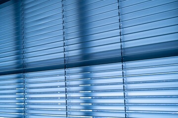 Workshop and office metal horizontal blinds line detail on background.