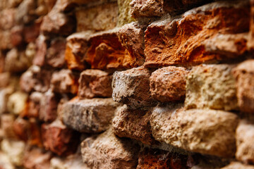 Close-up of rustic red and brown stone wall texture