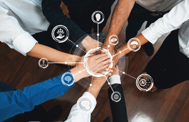 This image showcases a diverse group of hands joined together, symbolizing collaboration and...