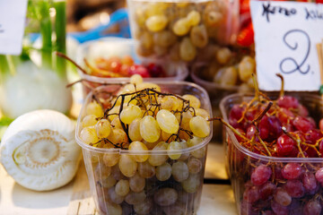 Fresh white and red grapes on display at market stall