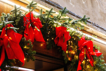 Festive holiday garland with red bows and lights