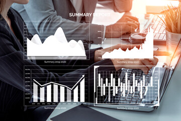 A focused business team reviews a summary report with various graphs and data visualizations on a laptop, enhancing collaboration and strategic decision-making. Impute