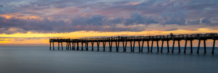 Sunset with dramatic clouds in sky over the Gulf of America formerlly the Gulf of Mexico at the Venice Fishing Pier in Venice Florida USA