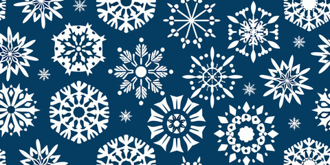 Intricate white snowflakes scattered across a deep navy blue background