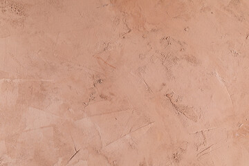 The interior wall is covered with pinkish-beige putty plaster