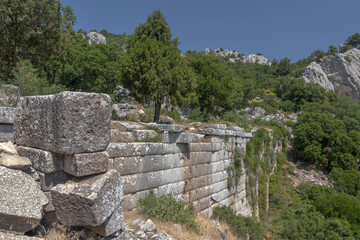 Ruins of the city of Termessos. An ancient city located high in the mountains of Turkey. The walls of the buildings in the ancient city are made of huge stone blocks. Masonry of ancient buildings.