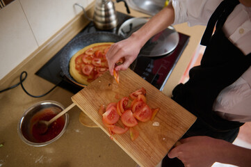 Fresh Tomato Pizza Prep: Chopped Tomatoes On Cutting Board While Cooking In Kitchen
