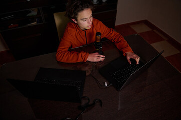 Young Creator Podcasting Setup With Laptop And Microphone At Home Desk