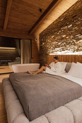 Relaxing in a cozy cabin while reading by the stone wall