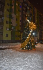 Beautiful winter landscape in the city park at night with Christmas decorations