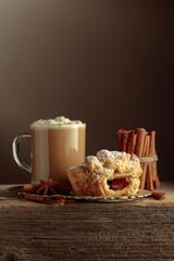 Vienna strudel and caffe latte on a silver tray.