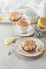 Meringue lemon tart on a white table.