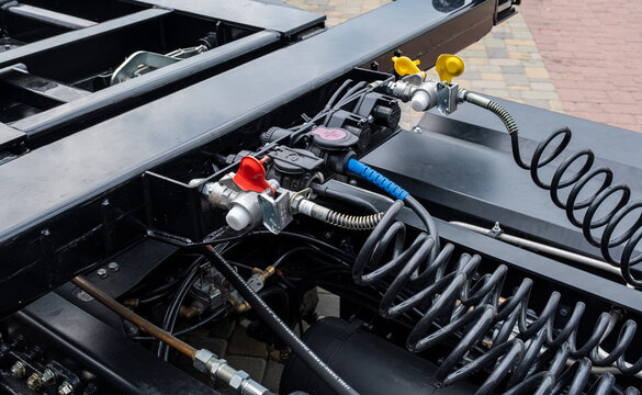 Pneumatic pumping hoses and connections of the body with the trailer to the truck. Closeup of pneumatic hoses for supplying compressed air to the truck. Semi-trailer, Truck MOT maintenance repair.