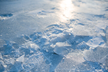 Background texture with cracked ice with snow close up.  Winter season.