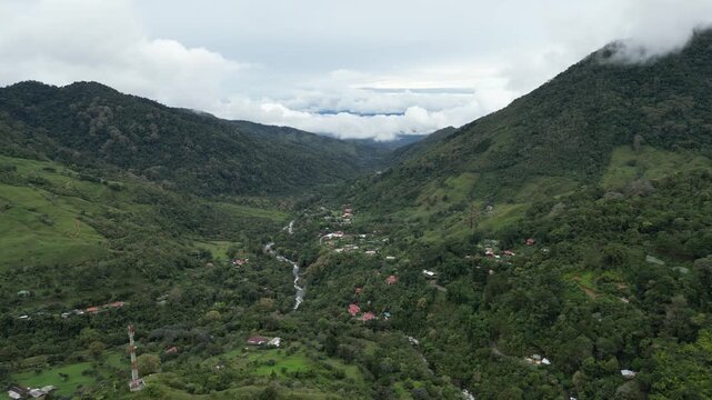 Aerial view of a small mountain village called San Gerardo de Rivas in a rural area with cloud forest surrounded by lush vegetation on the slopes of Cerro Chirripó in Costa Rica
