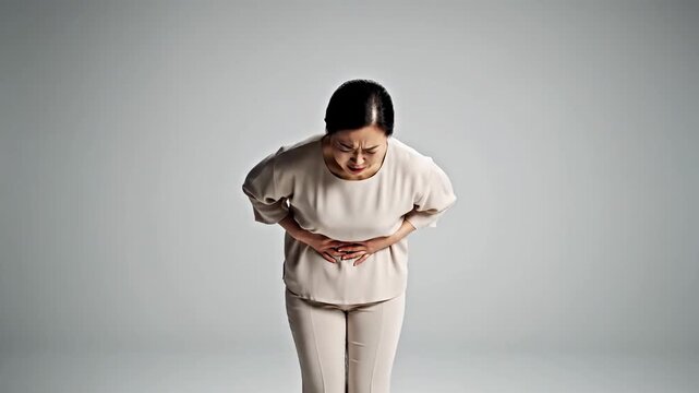 Expressing Female Discomfort and Pain in a Minimalist Grey Background