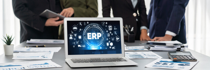 Panorama shot analyst team utilizing BI Fintech to analyze financial report with laptop. Businesspeople analyzing BI data dashboard displayed on laptop screen for business insight. Prodigy