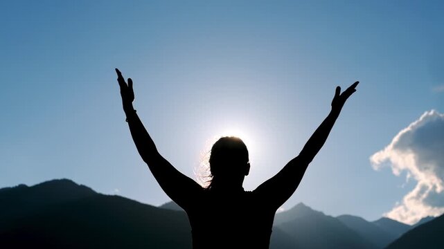 Woman practicing yoga poses silhouetted against mountain sunrise