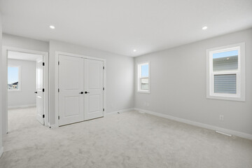 Bedroom with a white door and a white closet
