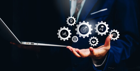 Digital workflow concept, businessman holding virtual gear icons system integration, business process automation, operational efficiency, smart technology, productivity optimization.