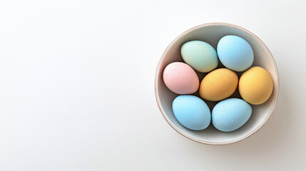 Colorful pastel Easter eggs in bowl on white background top view flat lay spring holiday decoration celebration traditional painted eggs minimal clean composition with copy space