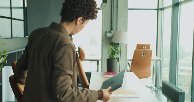 black woman project manager removing documents from bag