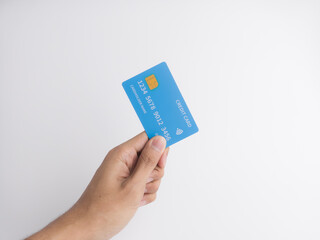Hand holding blue credit card isolated on white background for financial payment and shopping concept.
