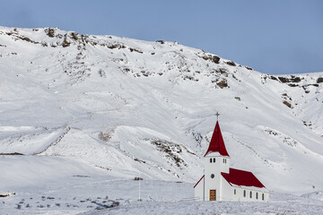 White church with red roof in winter landscape, Iceland.