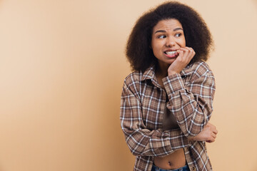 African American woman feeling anxious biting nails