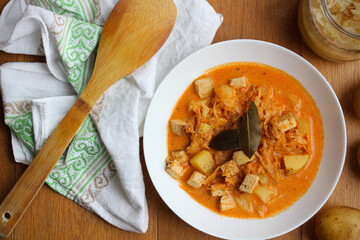 Healthy version of traditional Czech and Slovak cabbage soup (called zelnacka or kapustnica) cooked from sauerkraut, potatoes, cumin, sweet pepper, cream and smoked tofu cheese instead of sausage
