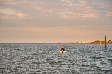 Fototapeta premium summer sunrise over the lagoon meets the sea, Bibione Pineda, Venice, Italy