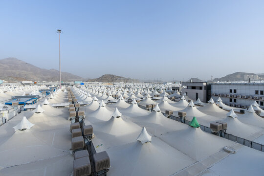 Mina, Mecca / Saudi Arabia - May 2025: Aerial view of the Mina tent city during the Hajj season, showing rows of white pilgrim tents organized across the valley near the holy city of Mecca.
