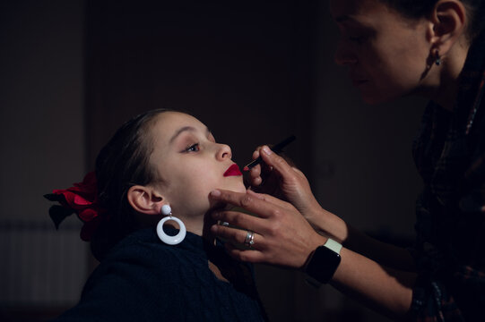 Mother Applies Lipstick To Daughter In Quiet, Intimate Beauty Moment - Powered by Adobe