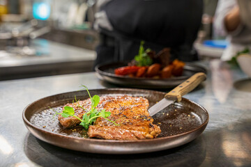 A chef at a professional restaurant kitchen prepare the ordered food before it leave to the guest room