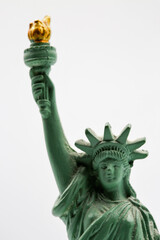Statue of Liberty miniature figurine souvenir with green patina closeup.