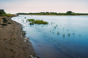 summer sunrise over the lagoon meets the sea, Bibione Pineda, Venice, Italy