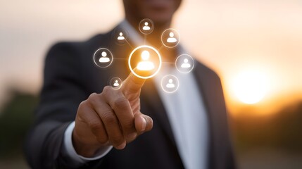 Businessman interacts with a glowing network of people icons at sunset symbolizing connections and strategic outreach
