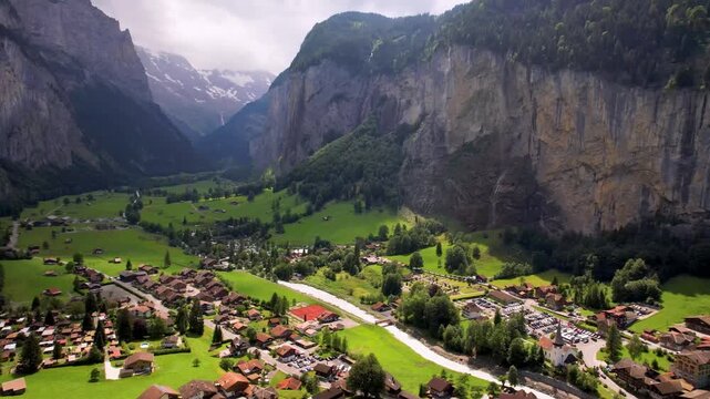 Switzerland nature and travel. Alpine. Beautifl traditional mountain village Lauterbrunnen with waterfalls surrounded by Alps. Popular tourist destination in canton Bernese oberland. Aerial drone view