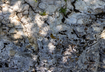 background , texture of stone mineralogical rocks in nature on a sunny day in a mountainous area, soft focus