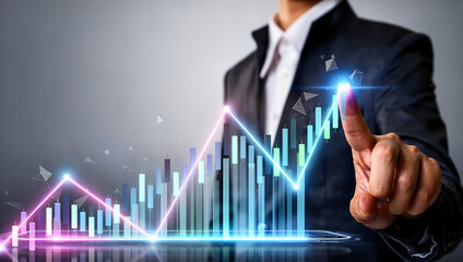 Businessman points to a glowing upward trend line on a financial graph showing growth and success.