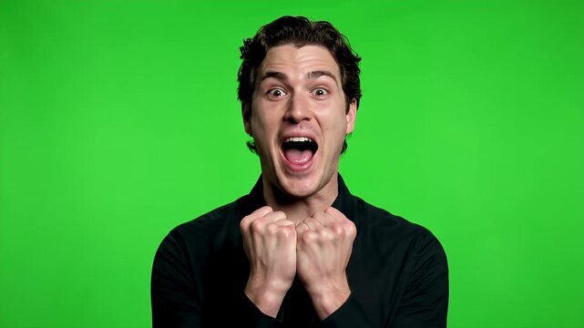 Excited Young Man Reacts with Surprise and Joy on Green Screen.