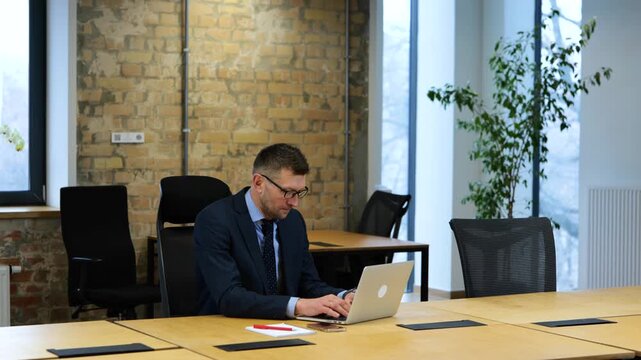 Woman coming to office and putting white envelop with salary on man table
