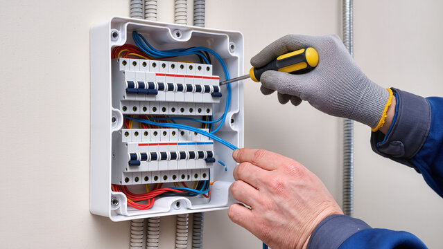 electrician fixing main fuse box 