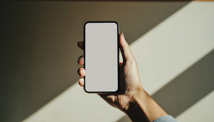 Hand holding smartphone with blank screen for mobile app mockup in Japan