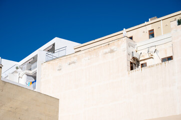 Old weathered limestone houses in vibrant colors in the coastal village of Marsaxlokk Marsaxlokk, Malta