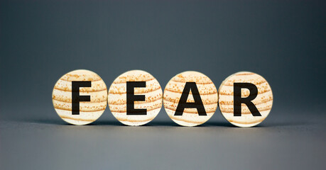 Fear symbol. Concept word Fear on beautiful wooden circles. Beautiful grey table grey background....