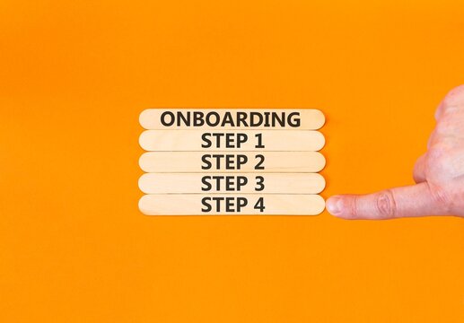 Time to step 4 onboarding symbol. Concept words Onboarding step 4 on beautiful wooden block. Businessman's hand. Beautiful orange background. Business success step 4 onboarding concept. Copy space.